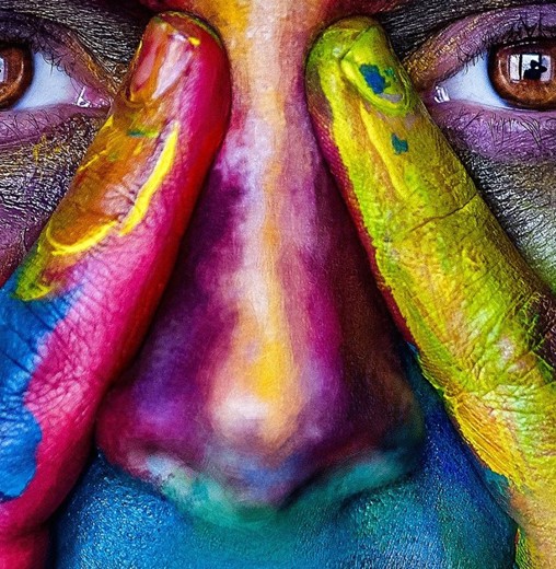 face with facepaint in many colours